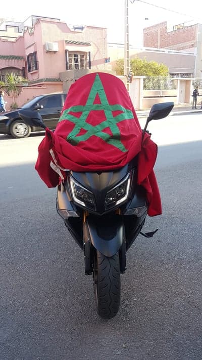 Moroccan flag draped over a black scooter