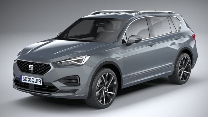 Metallic grey Seat Tarraco SUV with alloy wheels on a neutral studio background with soft overhead lighting.