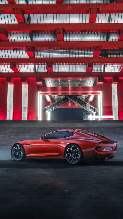 Red Concept Car Under Futuristic Red Architecture
