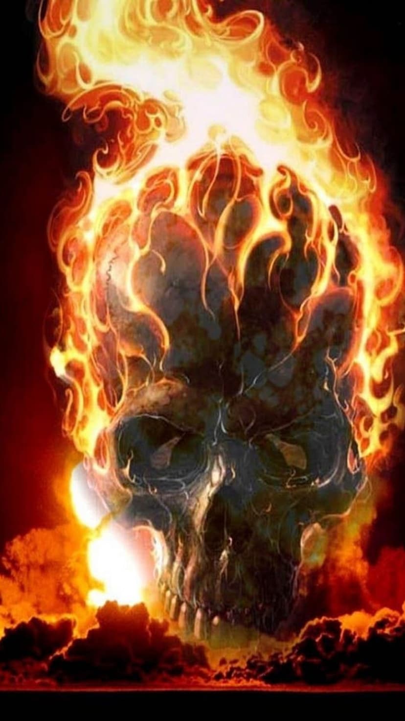 Flaming skeletal head with a wide-open jaw surrounded by swirling orange fire and sparks on a black background.