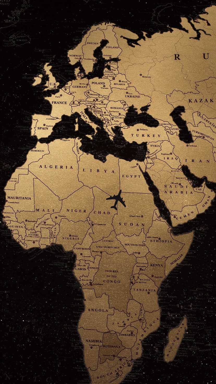 Golden world map with an airplane silhouette flying over the African continent against a dark starry background.