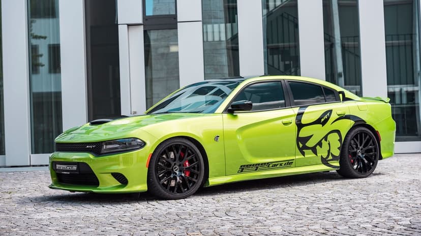 Lime green Dodge Charger SRT Hellcat with black decals parked on cobblestone before a glass building.
