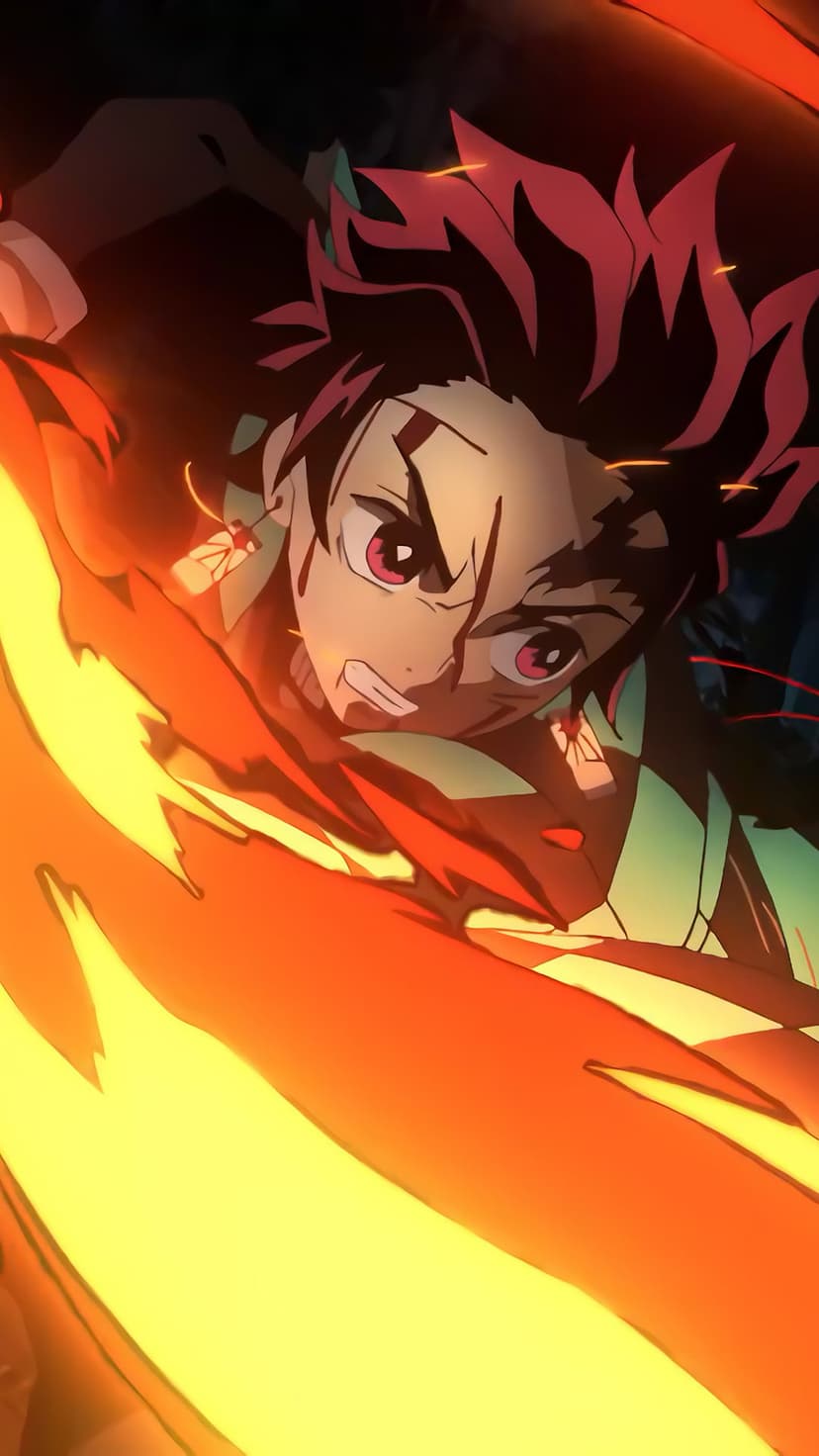 Tanjiro Kamado grips a glowing sword while surrounded by swirling orange fire and embers in a dark night setting.