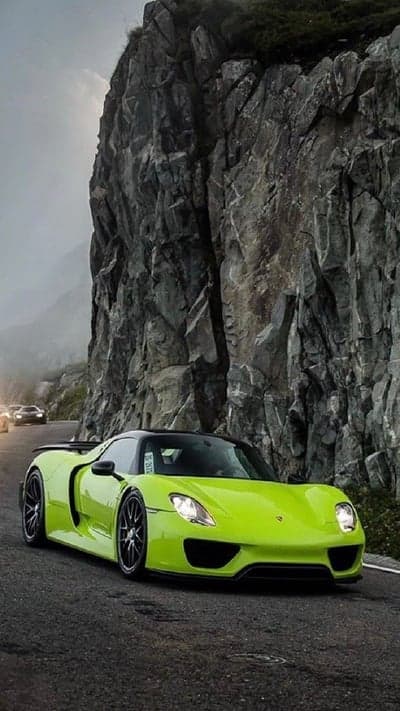 Emerald Porsche Racing Through Misty Peaks Phone Backdrop