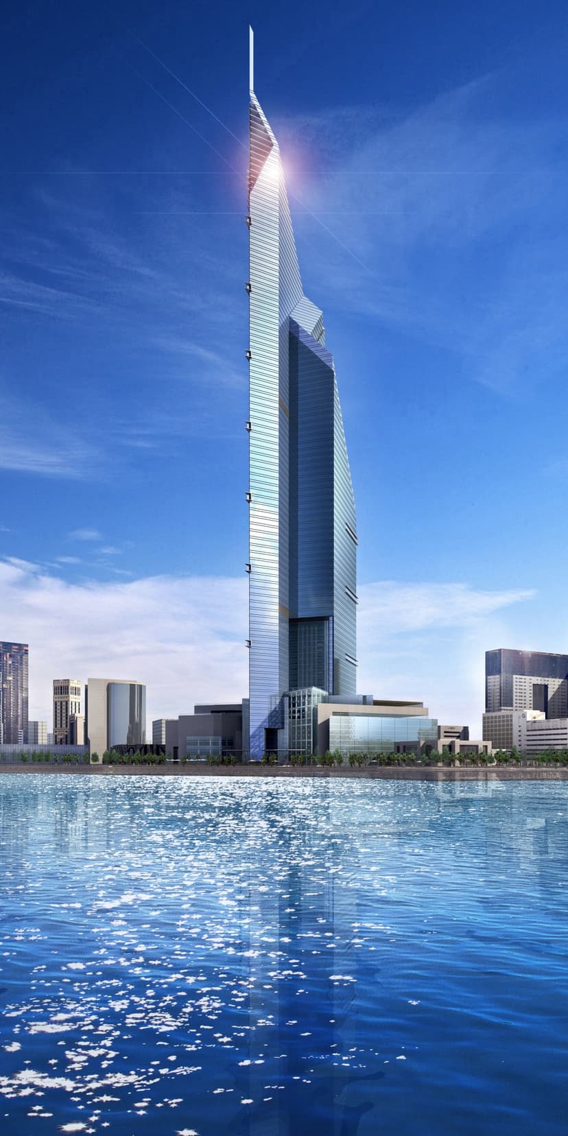 Pointed glass skyscraper standing beside a sparkling blue waterfront under a clear sky in a modern city skyline.