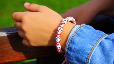 Child's Hand Wearing Personalized Alphabet Bead Bracelet