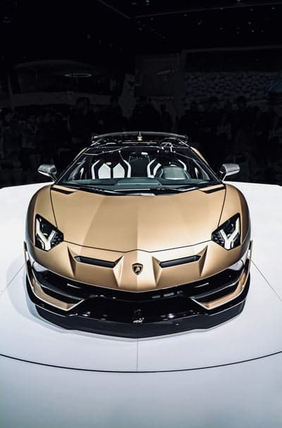 Gold Lamborghini Aventador SVJ Roadster Phone Background