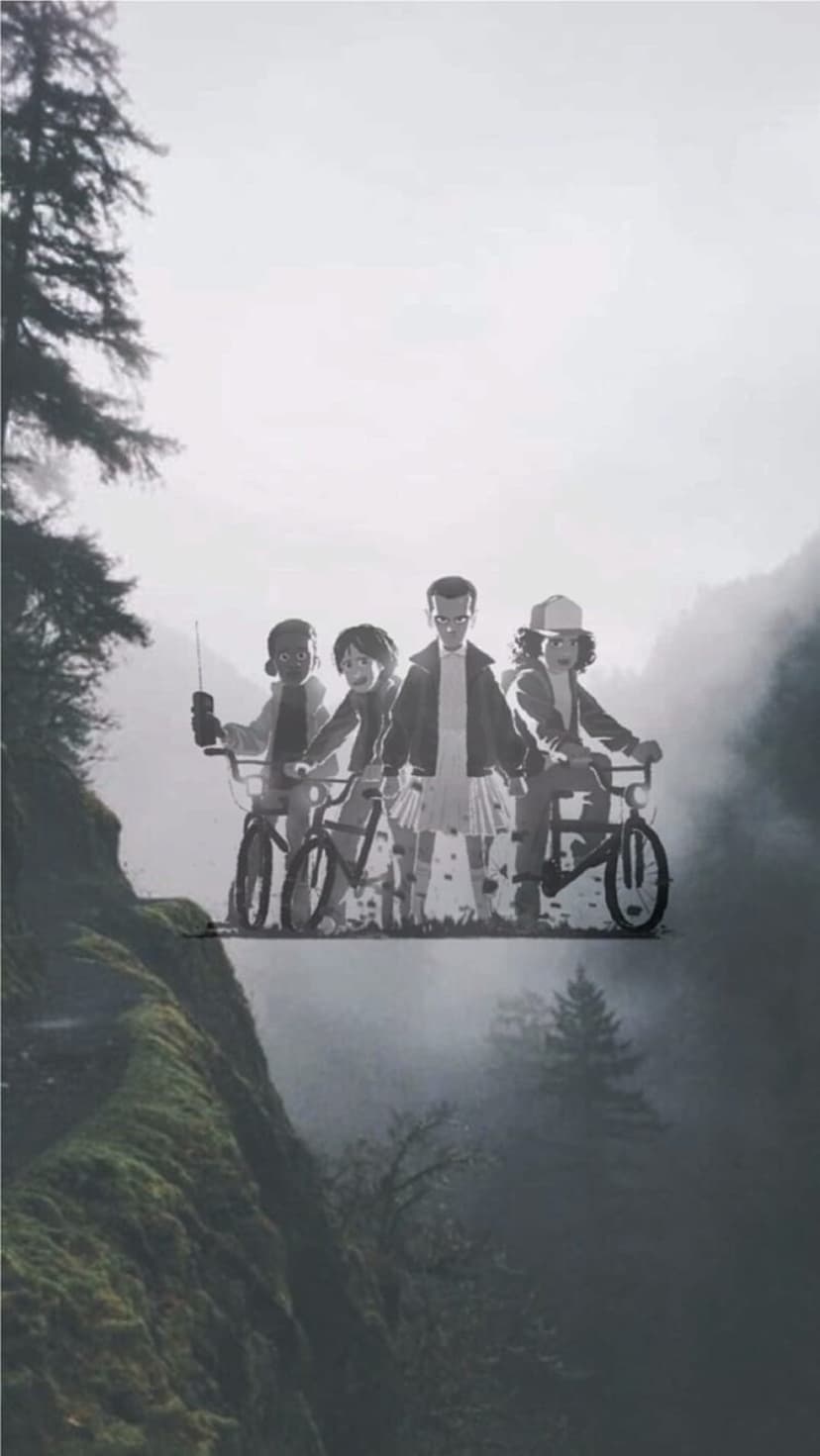 Group of children on bicycles riding through a thick foggy forest alongside a mossy vertical cliff face.
