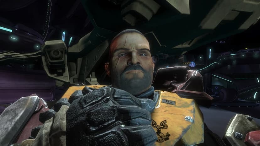 Jorge-052 unhelmeted in yellow armor with scars on his face inside a dark sci-fi spaceship hangar.