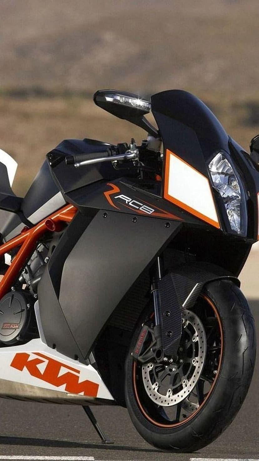 KTM RC8 sportbike highlights an orange trellis frame and aerodynamic fairings in a detailed close-up photography.