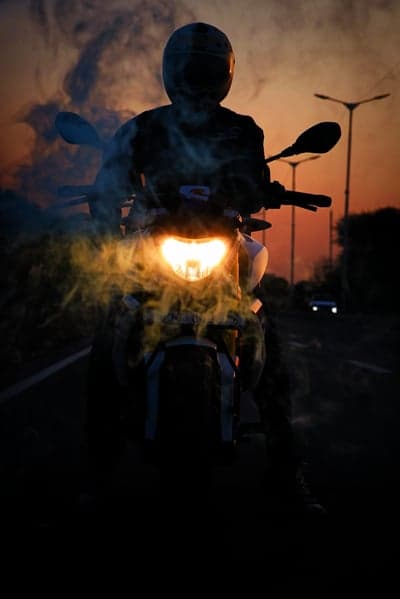 Mysterious Motorcycle Rider Sunset Smoke Phone Background