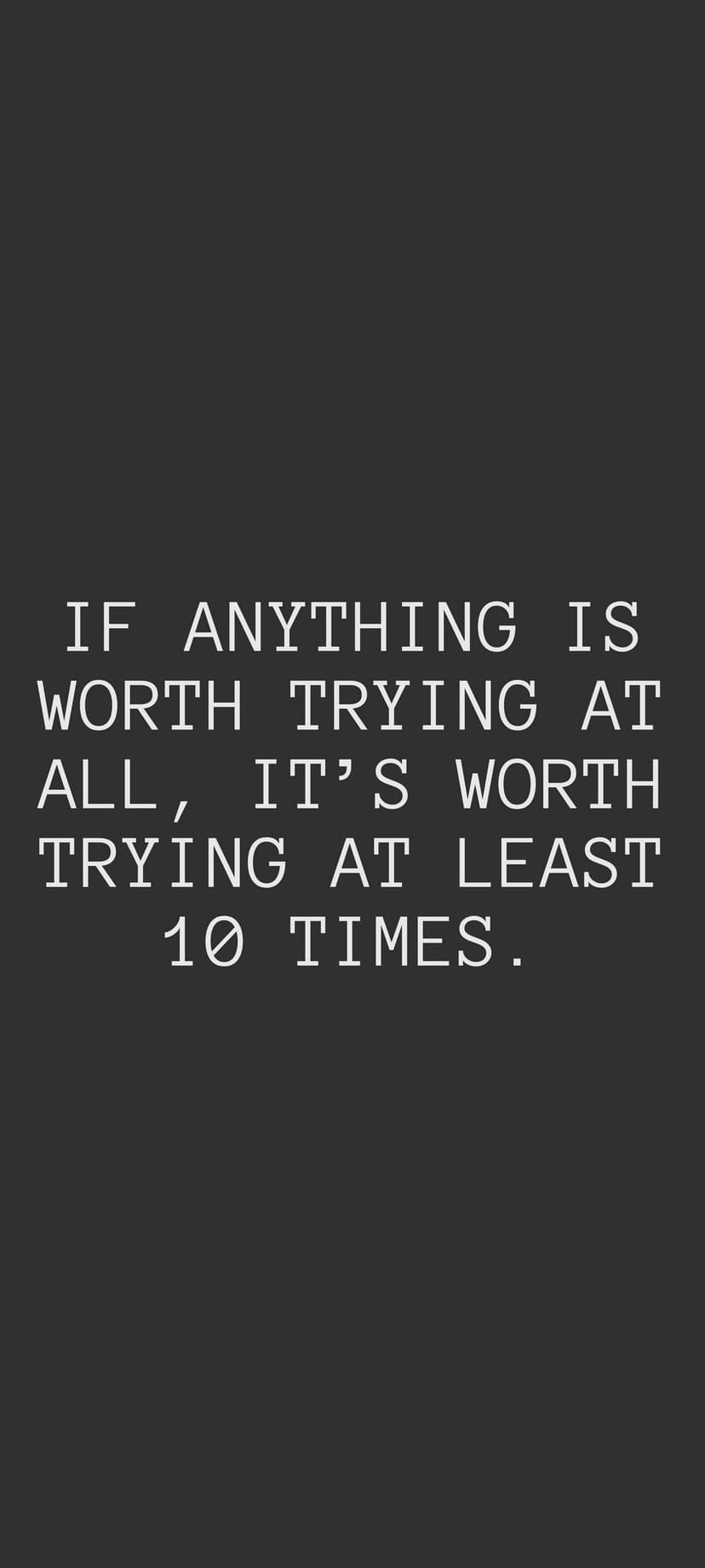 White block text on a solid dark gray surface stating a quote about trying ten times for worthwhile achievements.
