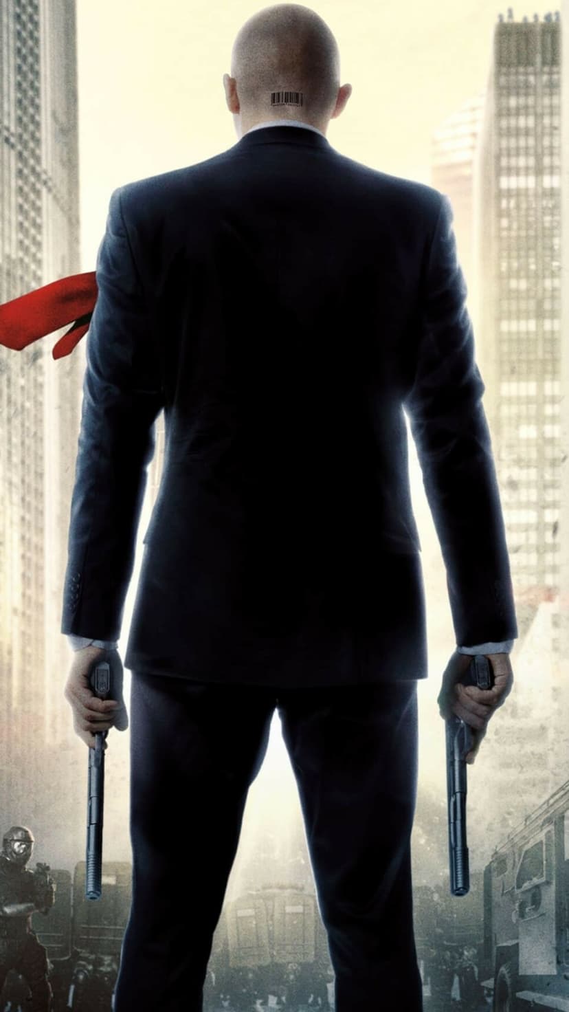 Agent 47 in a black suit with a barcode on his neck holding dual pistols against a city skyline.