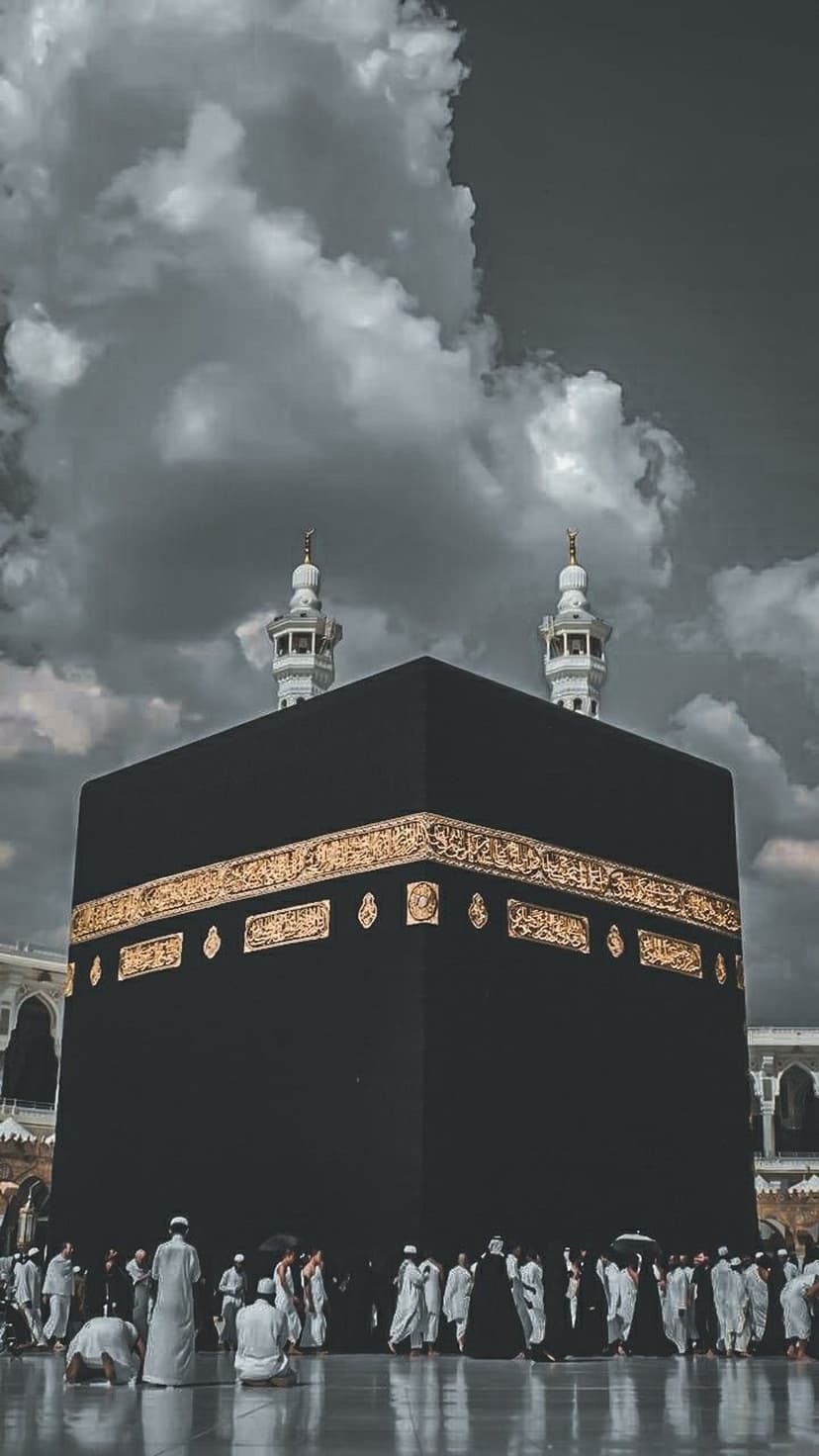 Kaaba draped in black and gold stands under dark clouds with pilgrims in white ihram gathered at the base.