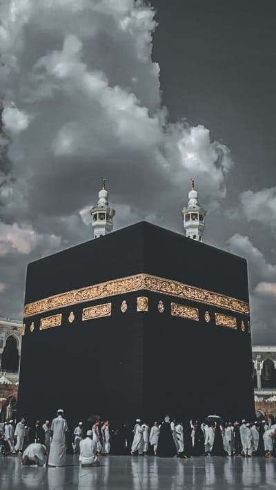 Kaaba in Mecca Under Dramatic Clouds with Pilgrims