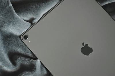 Silver iPad Pro on Plush Grey Fabric Mobile Background
