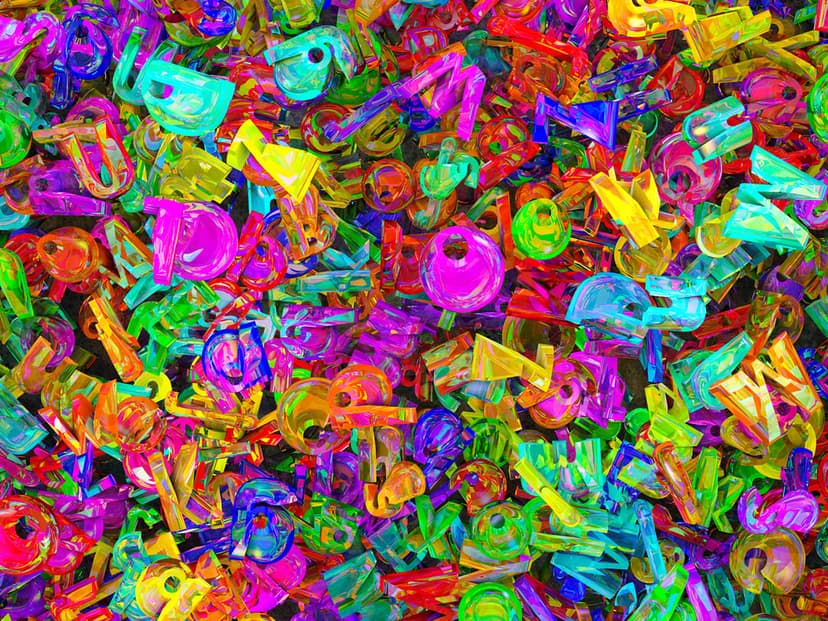 Translucent pink, blue, and green plastic musical notes and guitars in a glossy, top-down pile with soft lighting.