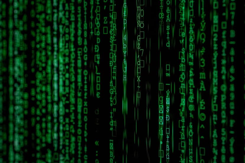 Vertical streams of luminous green symbols and binary-like characters descend across a pitch-black screen.