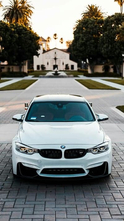 Pristine White BMW M4 Coupe at Sunset Mission Background
