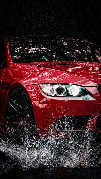 Red Sports Car Racing Through Rain Storm Phone Wallpaper