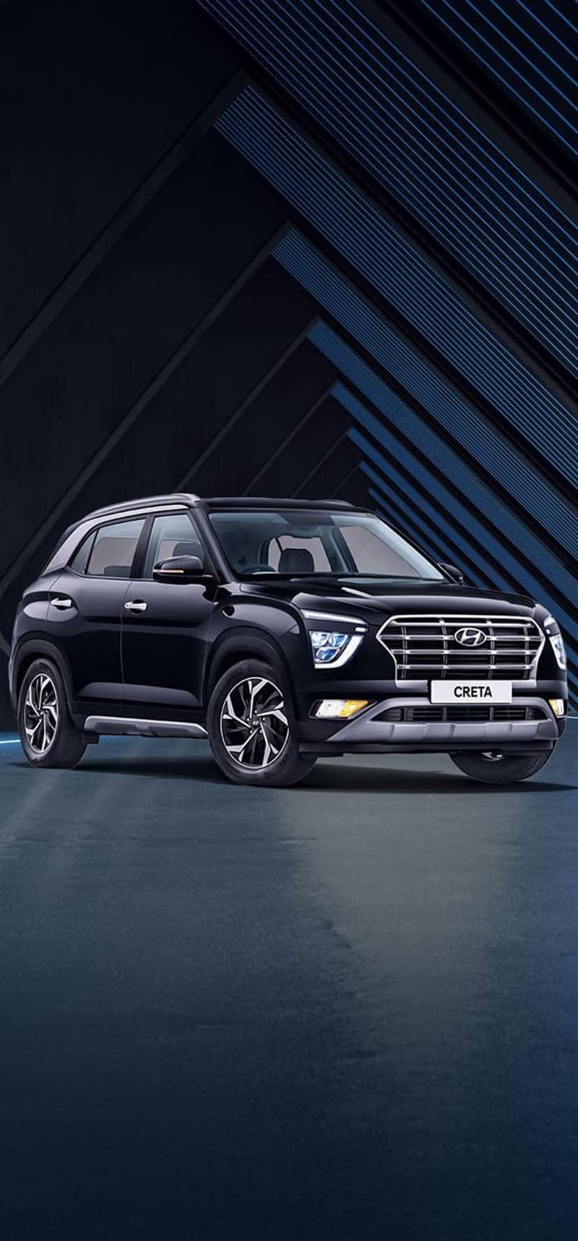 Black Hyundai Creta SUV with a silver grille and alloy wheels parked against a blue geometric backdrop.