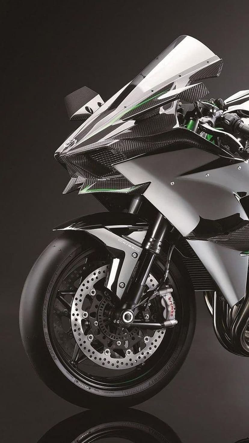 Kawasaki Ninja H2R front fairing with carbon fiber winglets and green frame accents on a dark background.