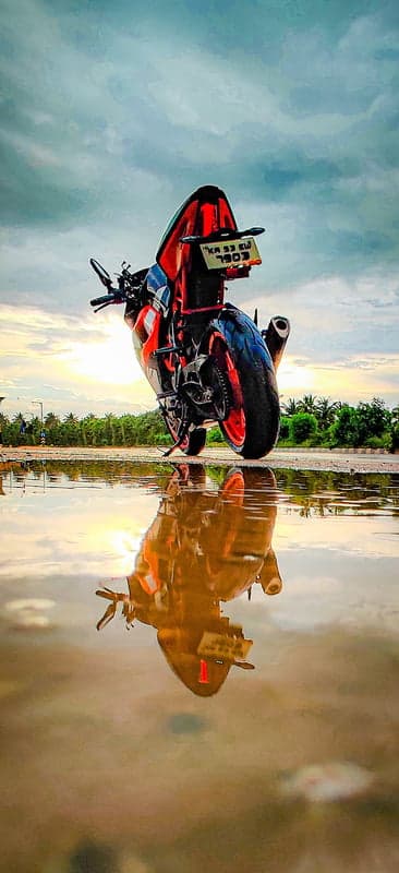 KTM Motorcycle Reflection in Water at Sunset