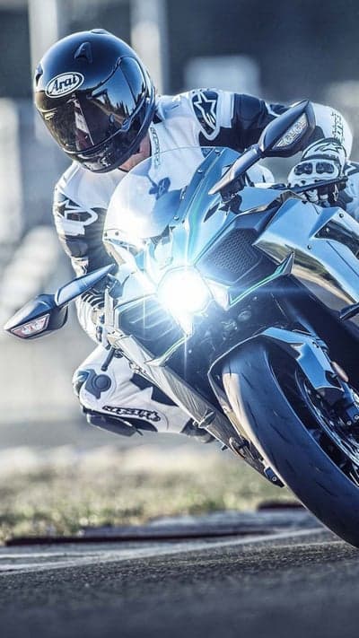 Motorcyclist in full gear races on a sportbike