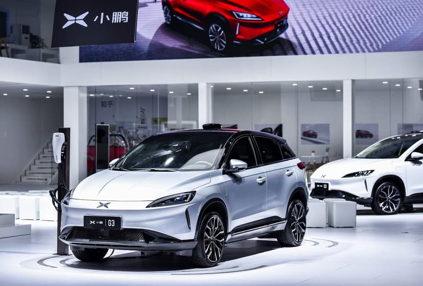 Silver Xpeng G3 electric SUV in a bright showroom with sleek metallic finish and sharp LED headlights.