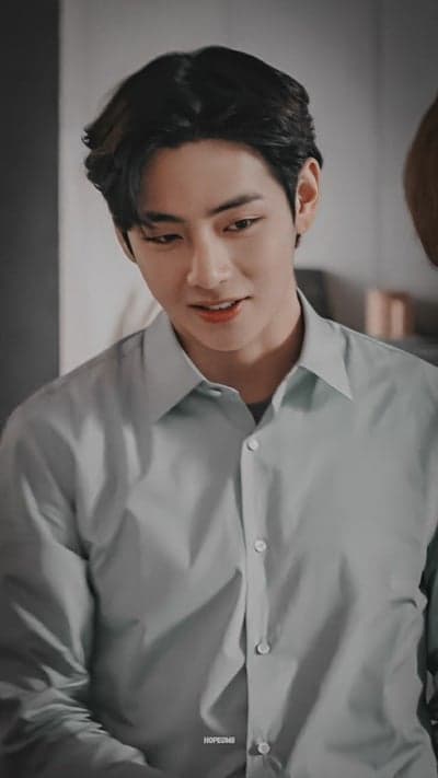 V from BTS in a light blue collared shirt