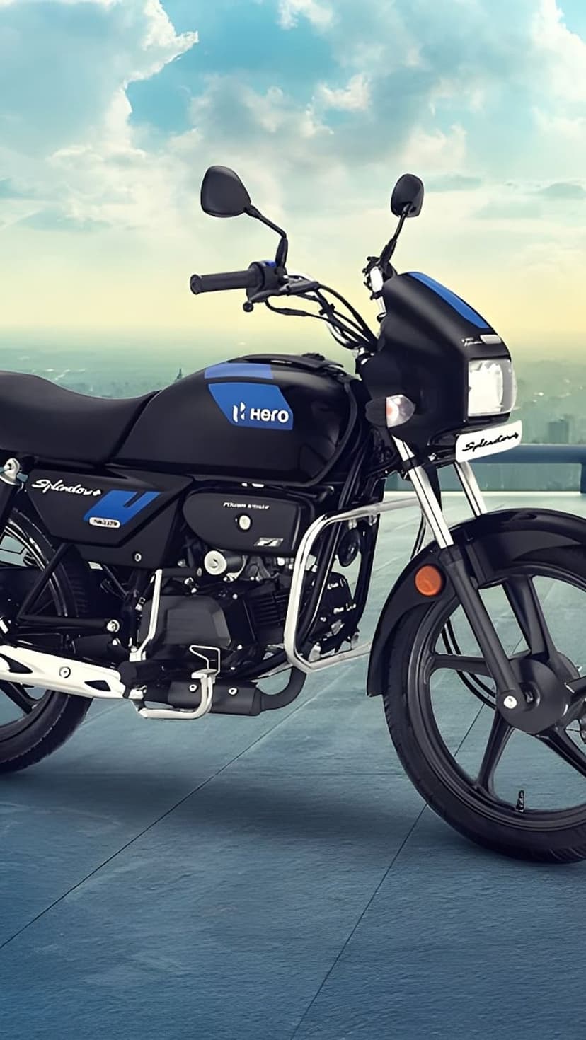 Hero Splendor Plus motorcycle in black and blue with side profile view against a soft cloudy sky background.