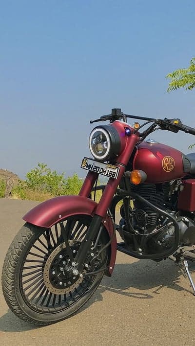 Maroon Royal Enfield motorcycle with custom wheels