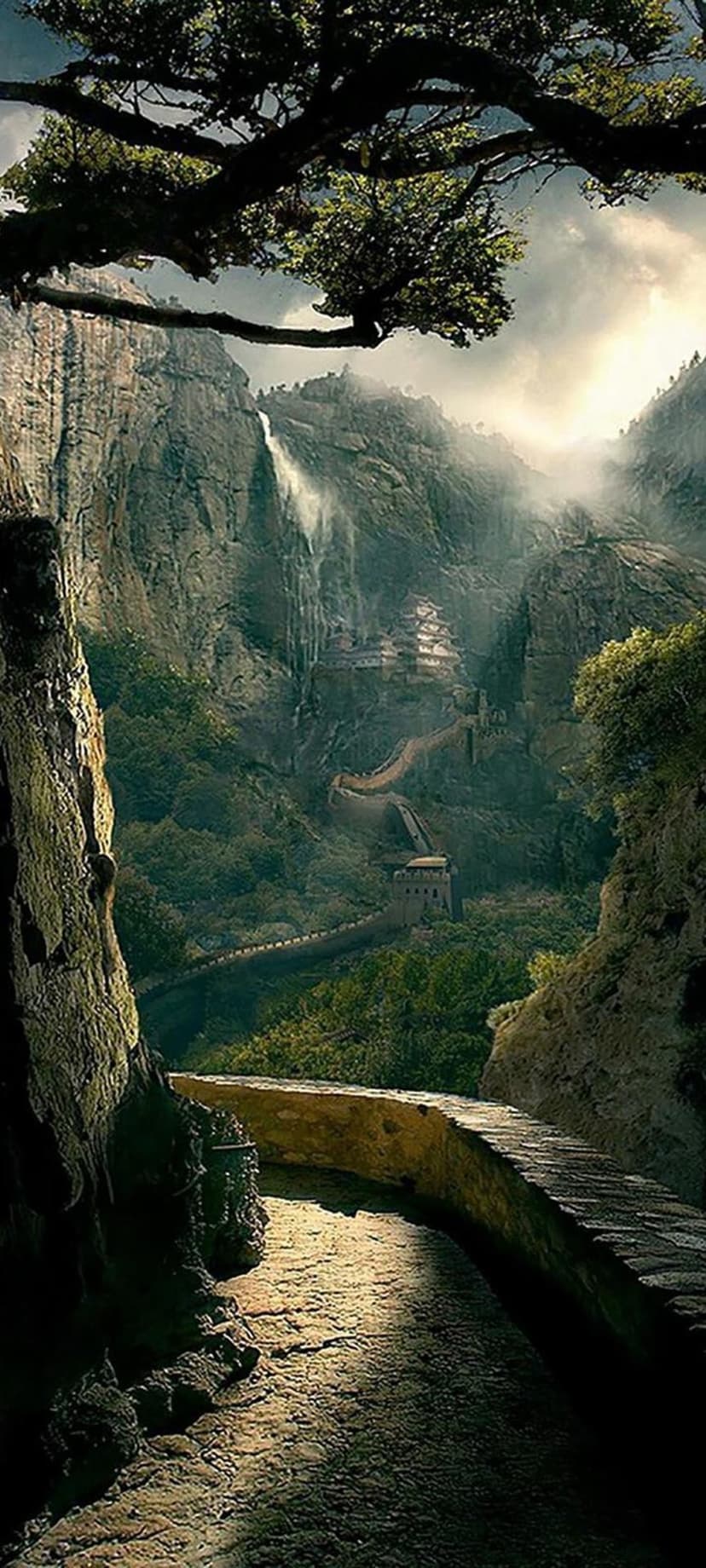 Massive waterfall cascades down a steep mountain next to a winding stone path under bright, cinematic sunlight.