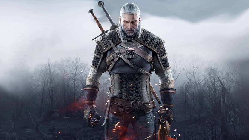 Geralt of Rivia in armor with two swords on his back standing in a misty forest with glowing orange embers.