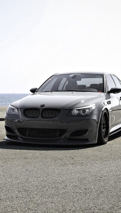 Dark Gray BMW M5 E60 on Pavement by Ocean