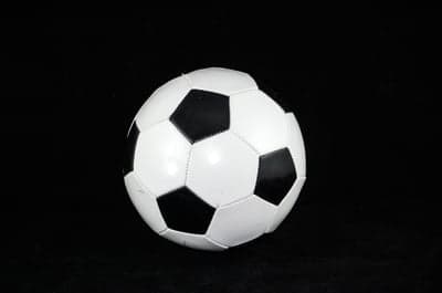 Classic Black and White Soccer Ball on Black Background