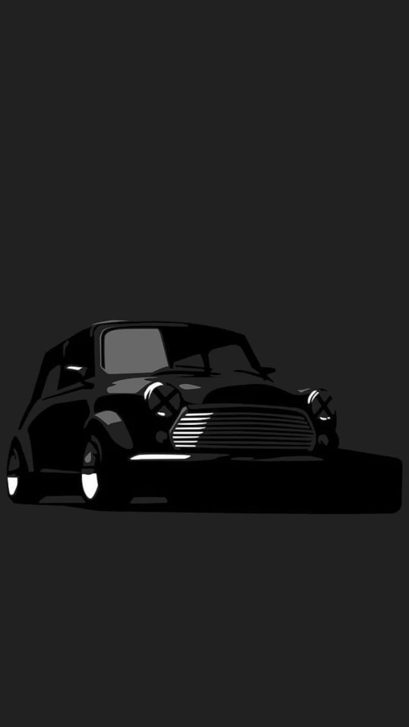Black Mini Cooper car featuring circular headlights and a chrome grille against a solid dark gray background.