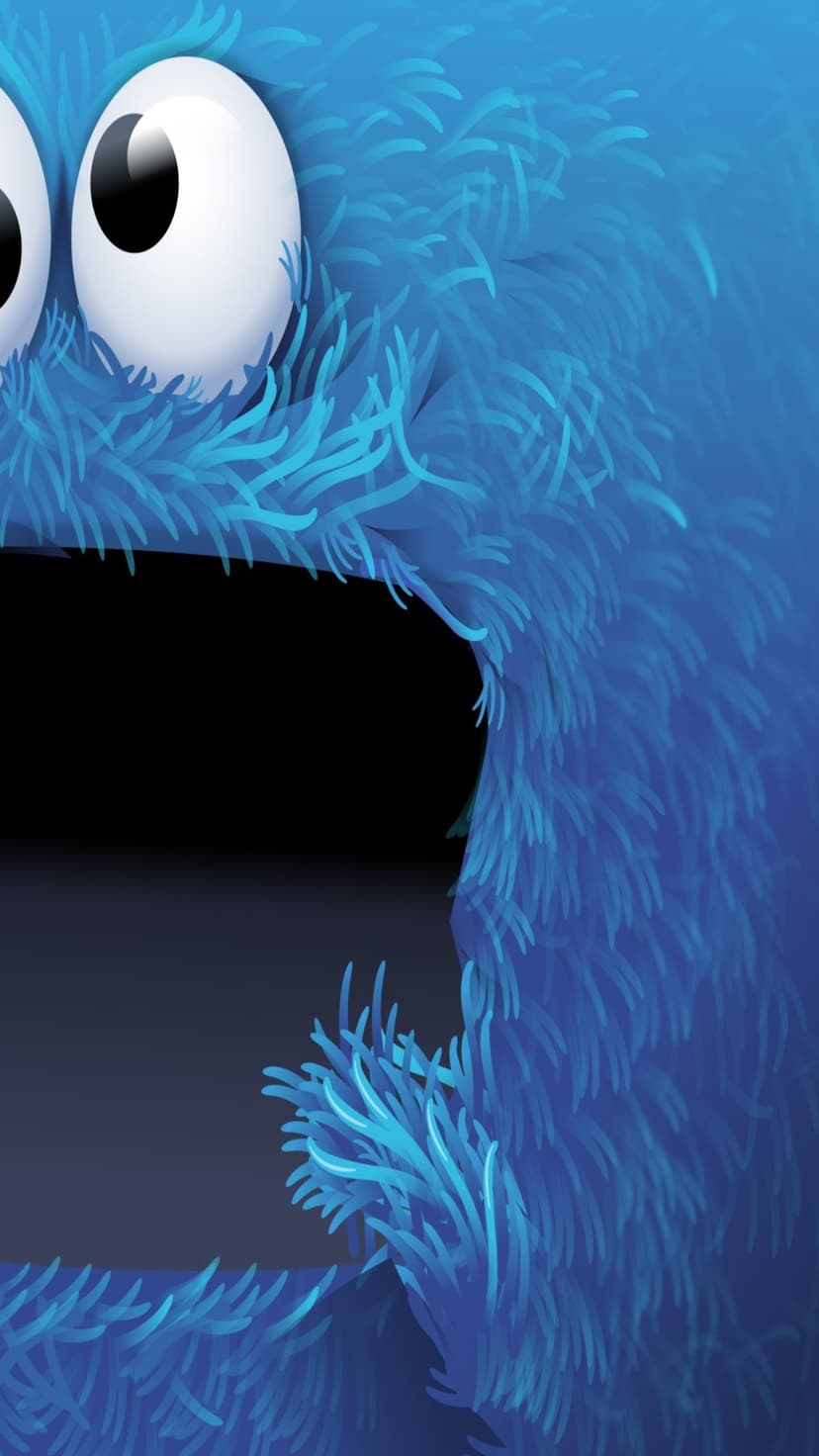 Cookie Monster with shaggy blue fur and large white googly eyes above a dark mouth in a close-up portrait view.