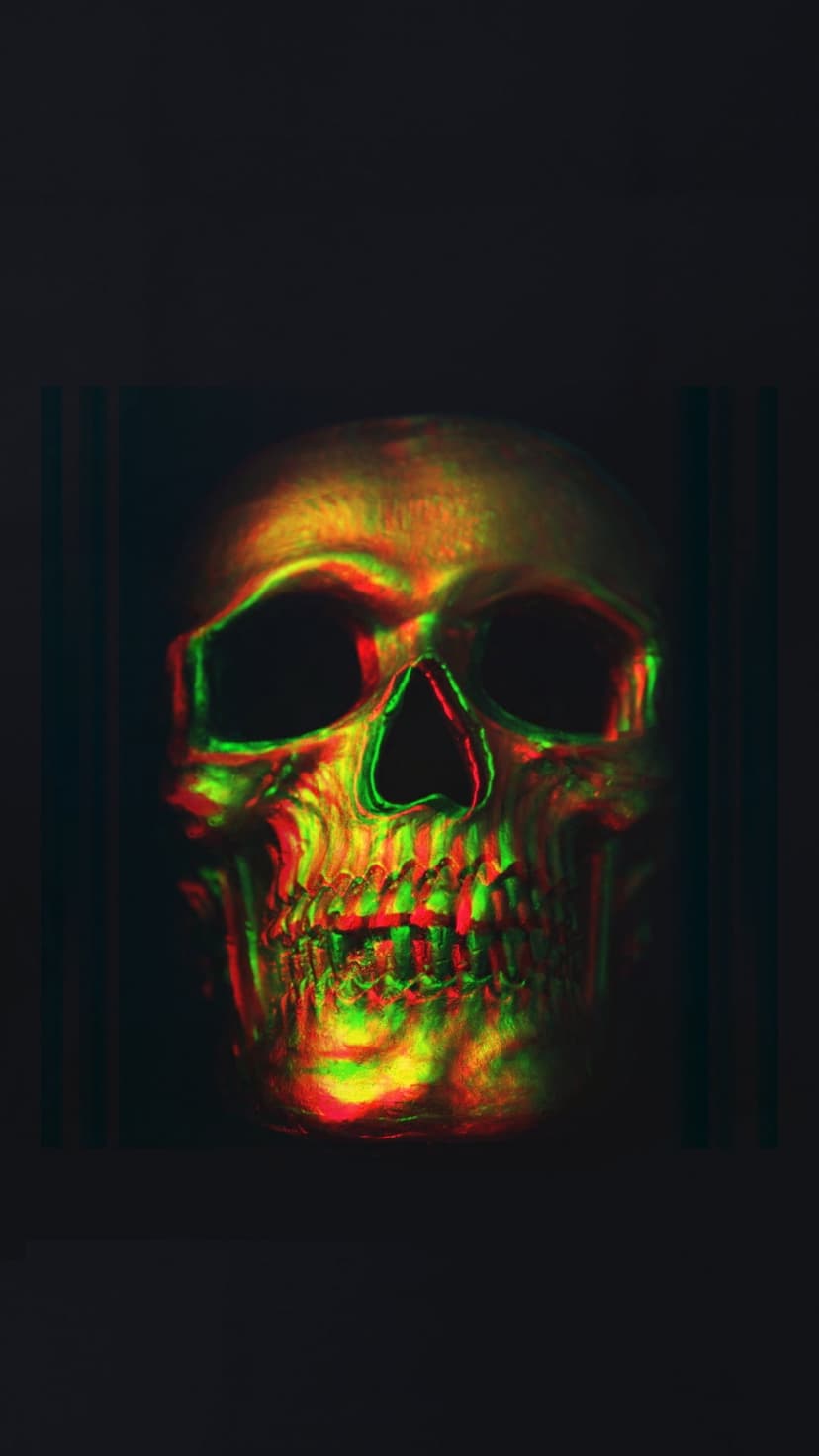 Human skull with red and green chromatic aberration glitch effects centered against a solid black background.
