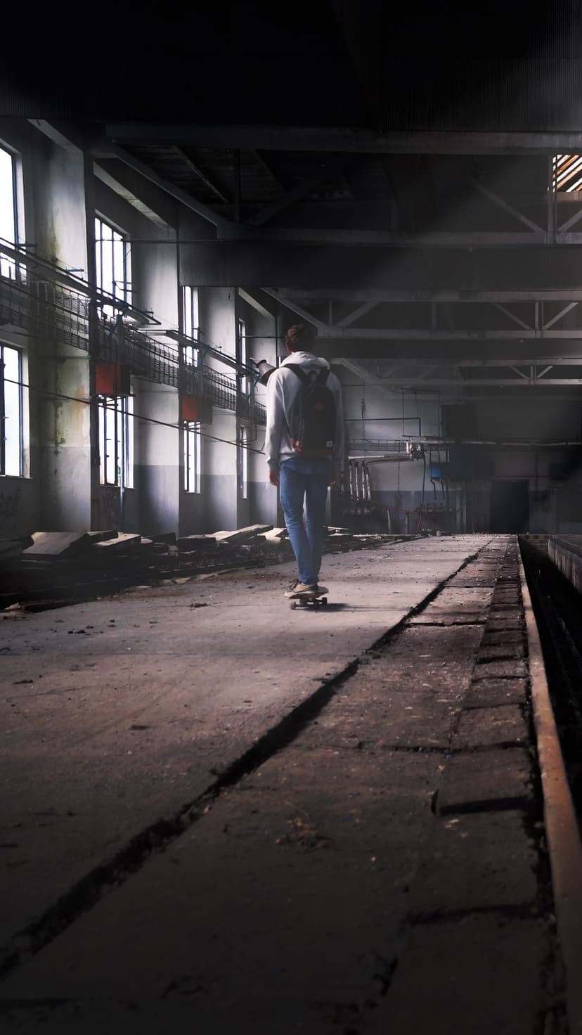 Lone Skater Exploring Urban Decay Industrial Phone Background