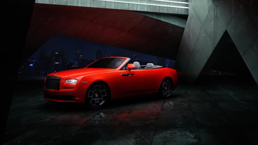 Red luxury convertible car parked under a concrete bridge with a night city skyline in the background.