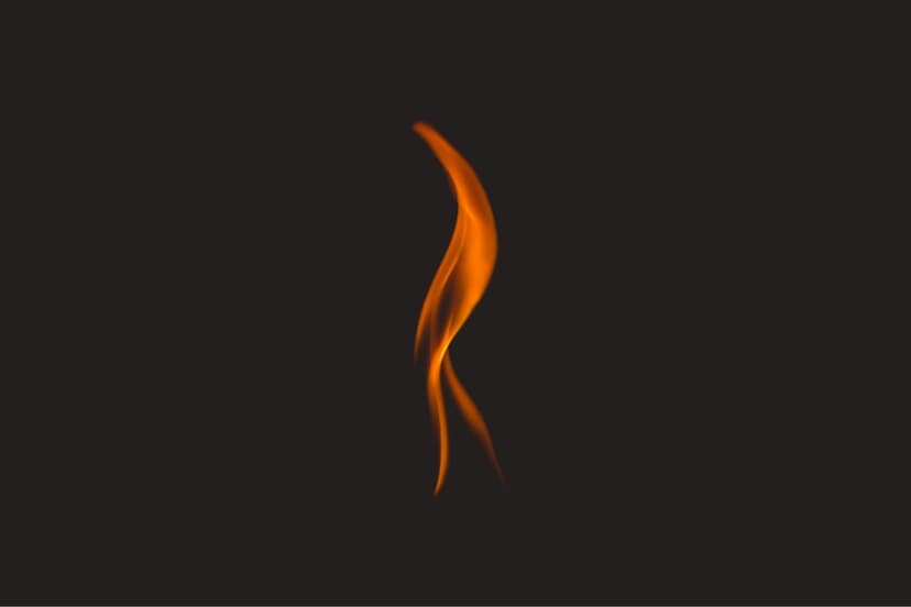 Vibrant orange flame spiraling upwards with glowing embers and ethereal wisps against a dark black background.