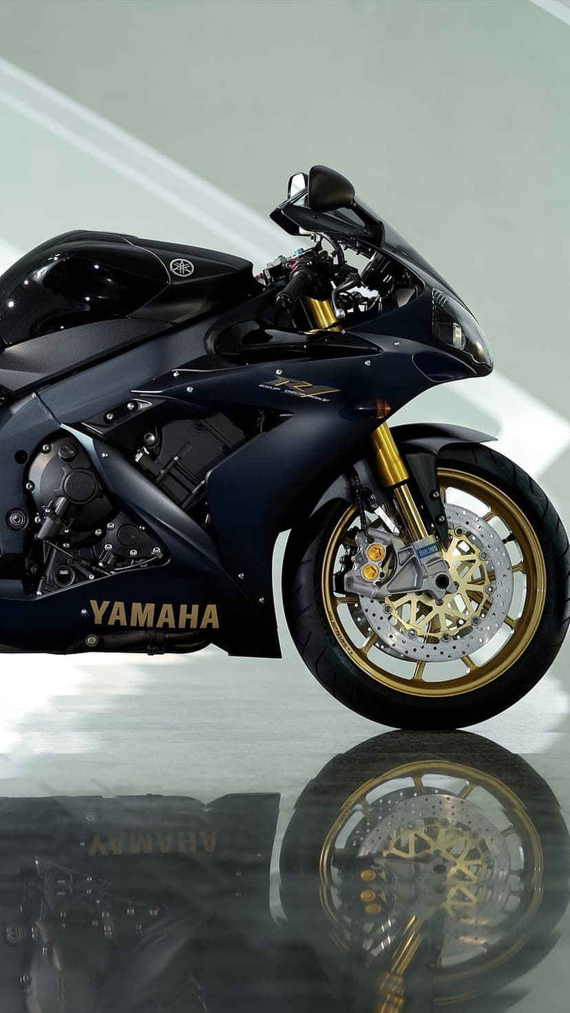 Yamaha R1 sportbike with navy blue fairings and gold alloy wheels shown in a detailed vertical close-up shot.