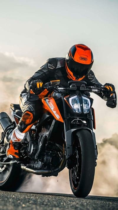 KTM Motorcycle Rider Performing Burnout in Dust