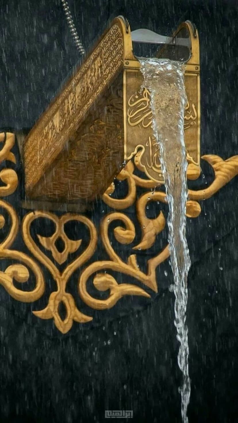Golden Arabic calligraphy on the Kaaba glistens under falling rain droplets during a storm in Mecca.