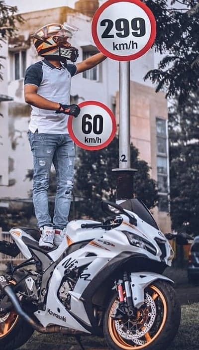 Motorcyclist Poses with Speed Limit Signs on Sportbike