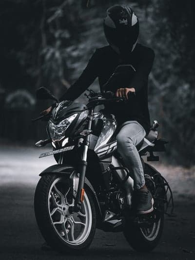 Man on Motorcycle in Moody Forest Setting