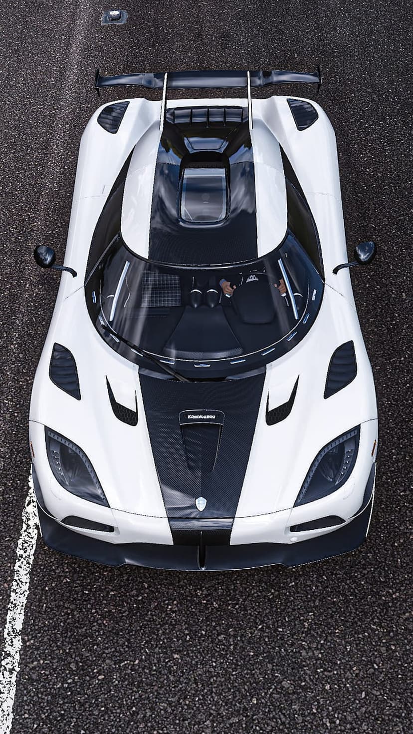 White Koenigsegg supercar with black stripes seen from directly above on a dark asphalt racetrack surface.