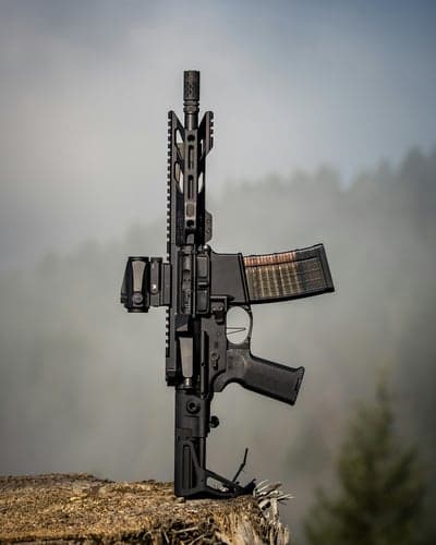 Modern AR-15 rifle with optic and loaded magazine