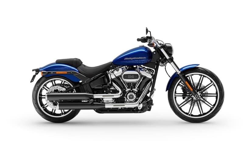 Blue Harley-Davidson Breakout motorcycle with a chrome V-twin engine and black exhaust against a white backdrop.